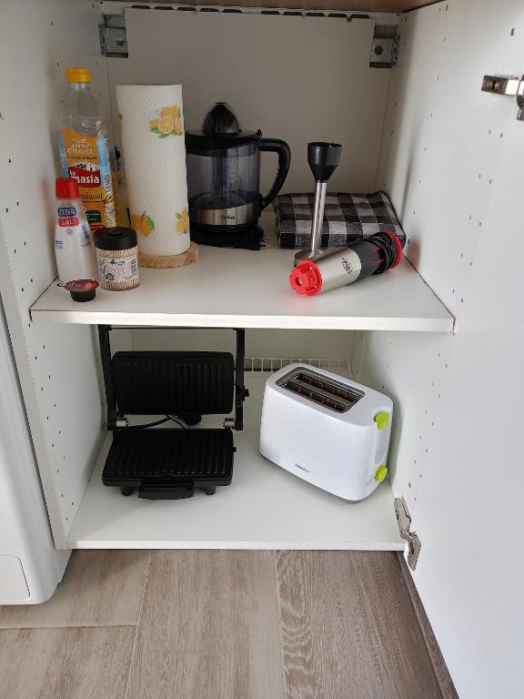 a kitchen cabinet with a toaster and a toaster at La Lunita in Valverde