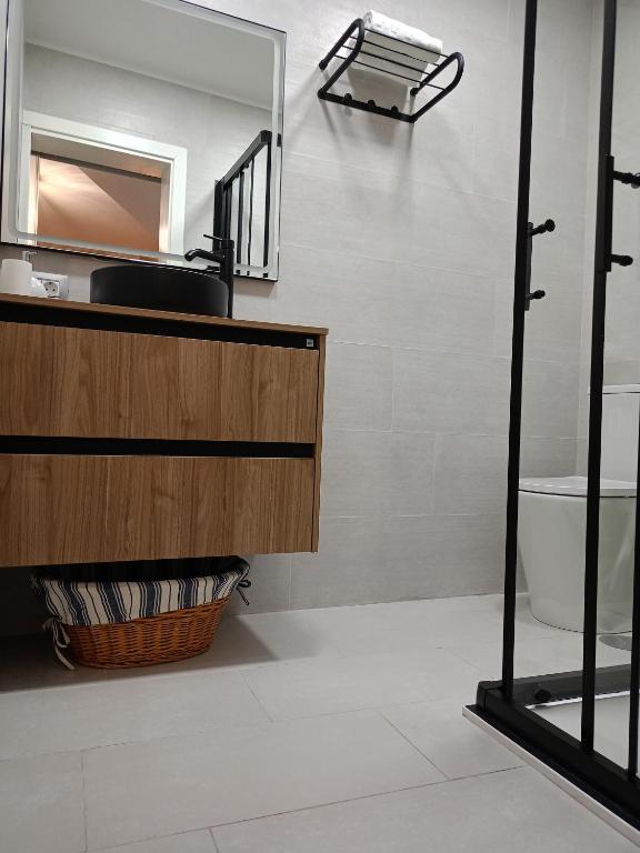 a bathroom with a sink and a mirror at La Lunita in Valverde