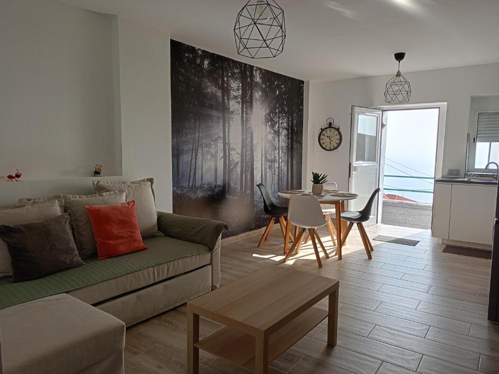 a living room with a couch and a table at La Lunita in Valverde