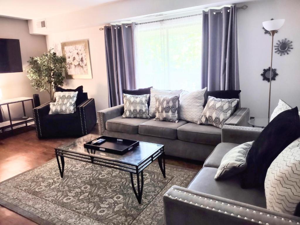 a living room with a couch and a coffee table at Inviting Condo in Central Raleigh in Raleigh