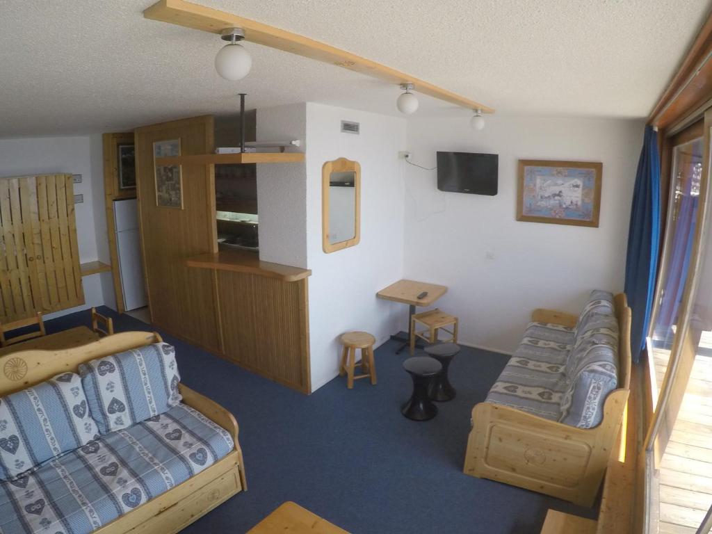 a room with two beds and a couch and a table at Appartement lumineux 60m² · 2 ch. · Balcon · WIFI · Parking - FR-1-346-557 in Arc 1800