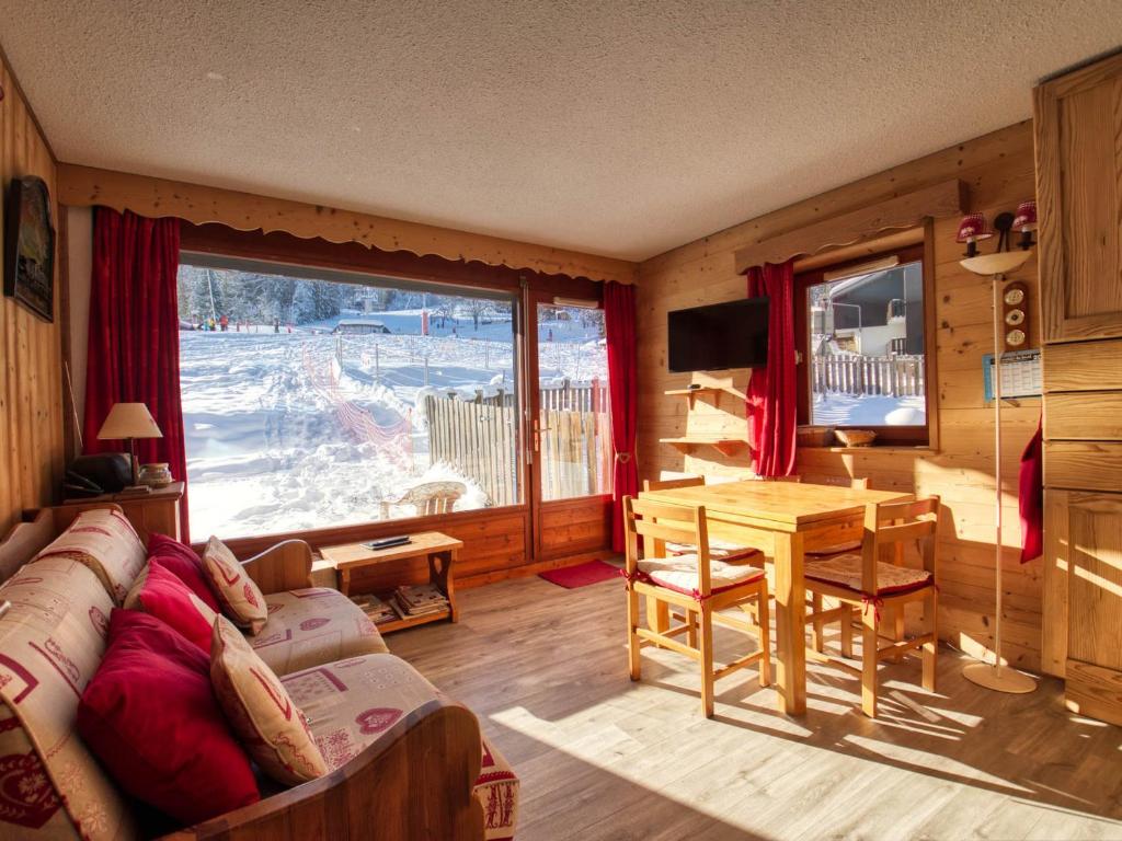 a living room with a couch and a table and a window at Appartement Morillon Village, 3 pièces, 7 personnes - FR-1-642-84 in Morillon