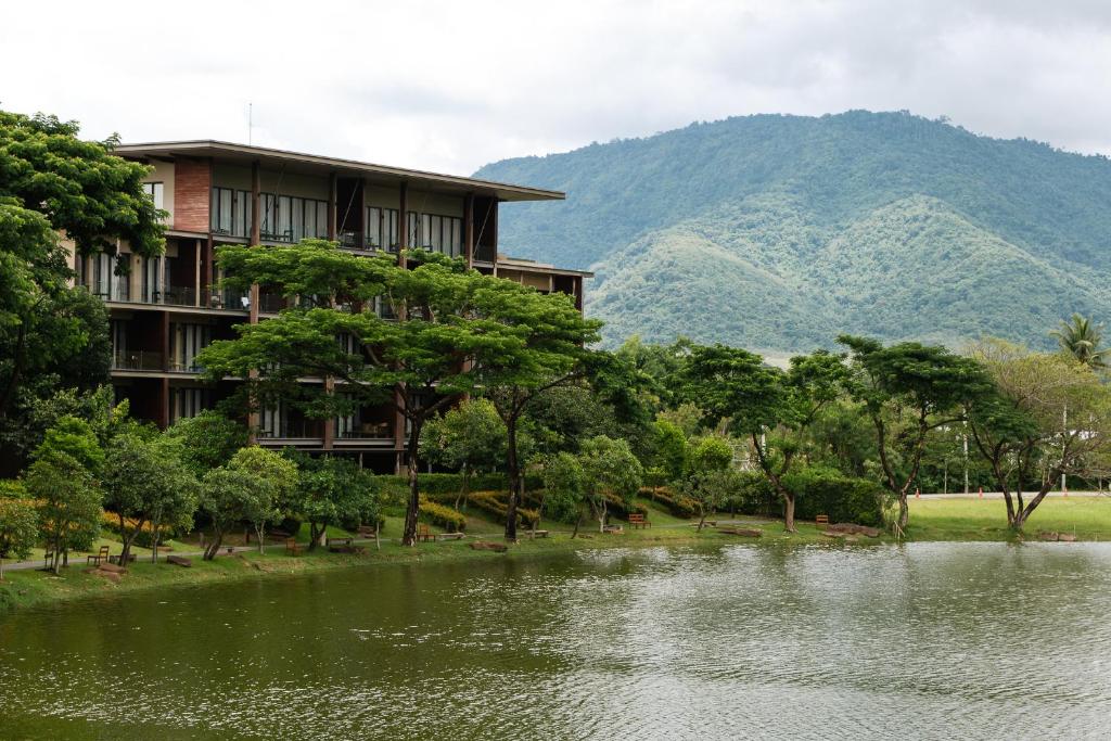 a resort with a lake and mountains in the background at Atta Lakeside Resort Suite - SHA Plus Certified in Mu Si
