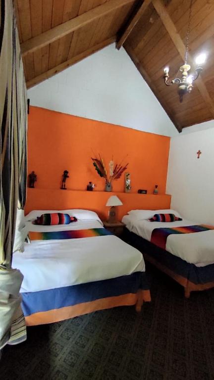 Postel nebo postele na pokoji v ubytování Cabañas Los Cactus