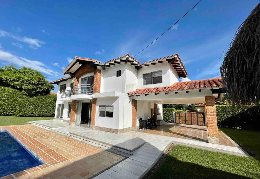 une grande maison blanche avec une piscine dans l'établissement comfortable country house, à Pereira