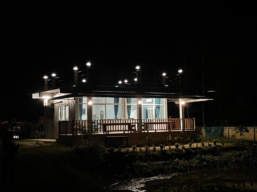 a house with lights on top of it at night at มองภู โฮมสเตย์ in Ban Fang