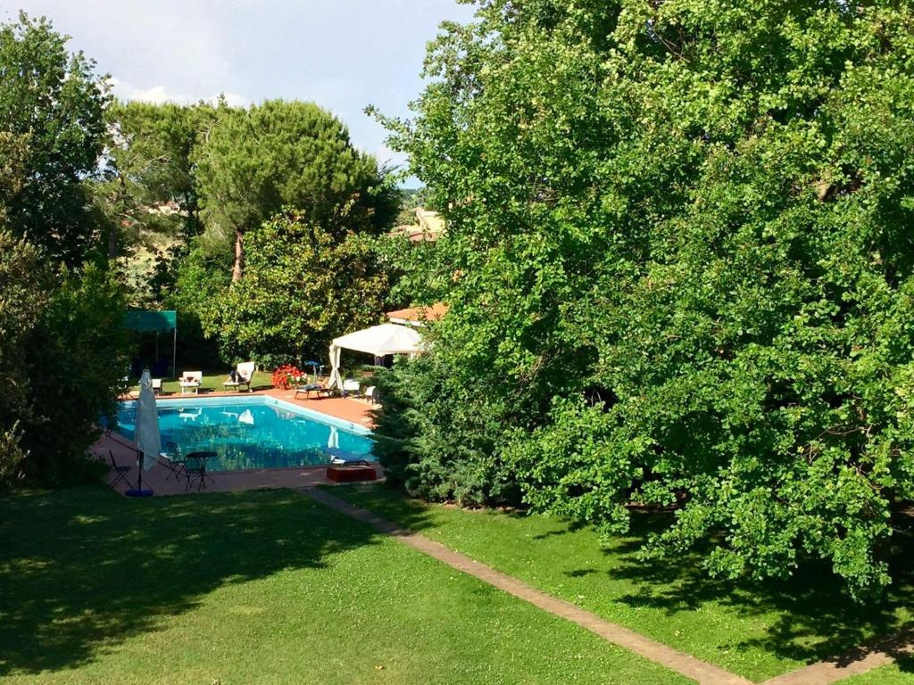 a view of a yard with a swimming pool and trees at Borgo Caere in Ladispoli