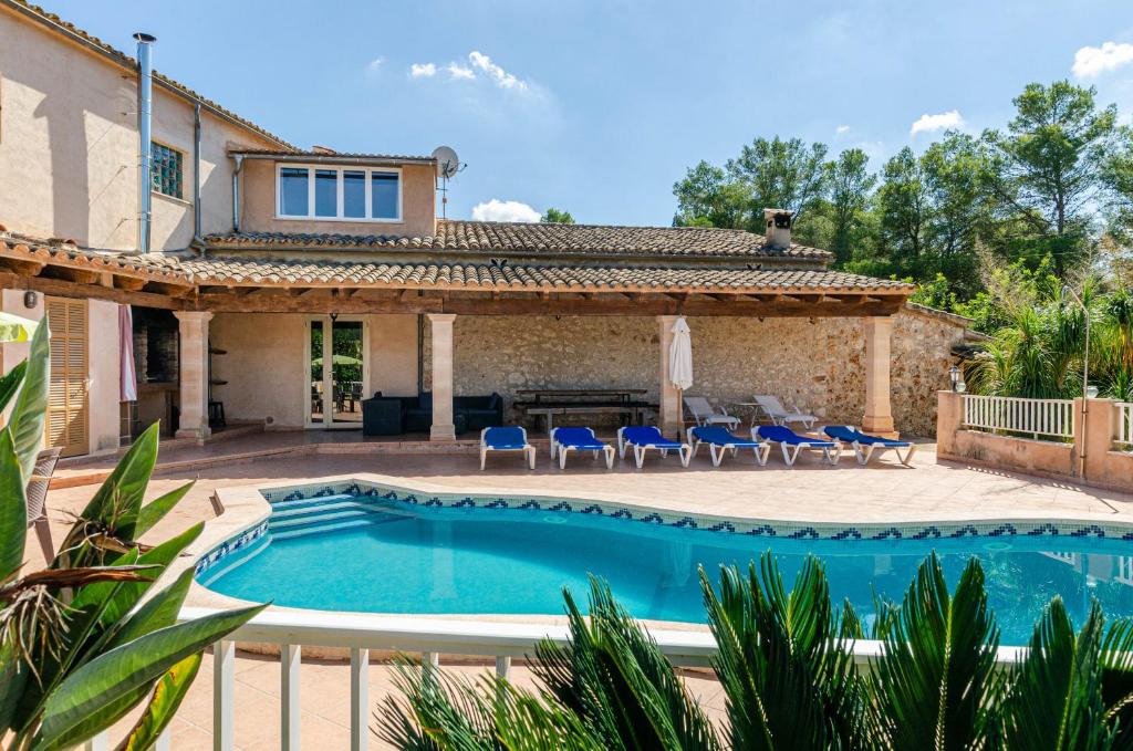 a house with a swimming pool in front of a house at YourHouse Es Pleto Villa in Lloret de Vistalegre