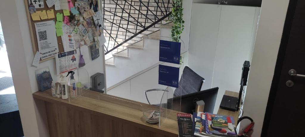 an office with a reception desk with a staircase at Apartman 25 in Belgrade