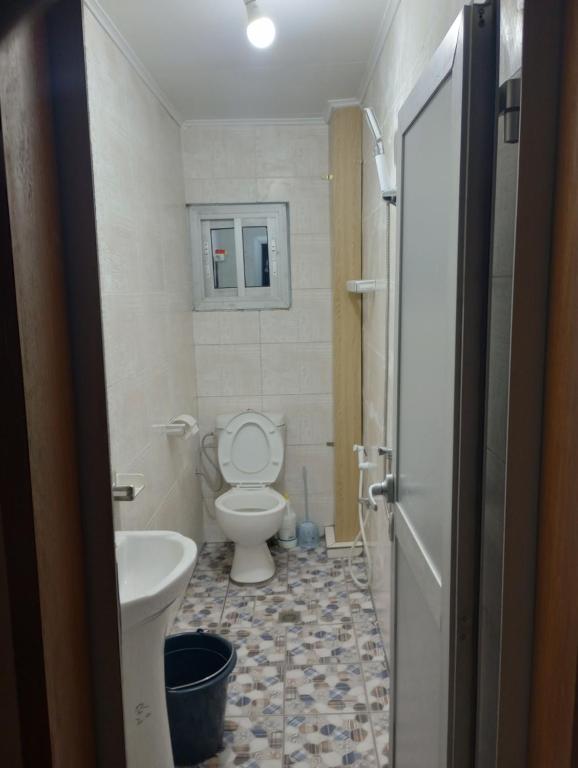 a small bathroom with a toilet and a sink at ANGELA HOME in Douala