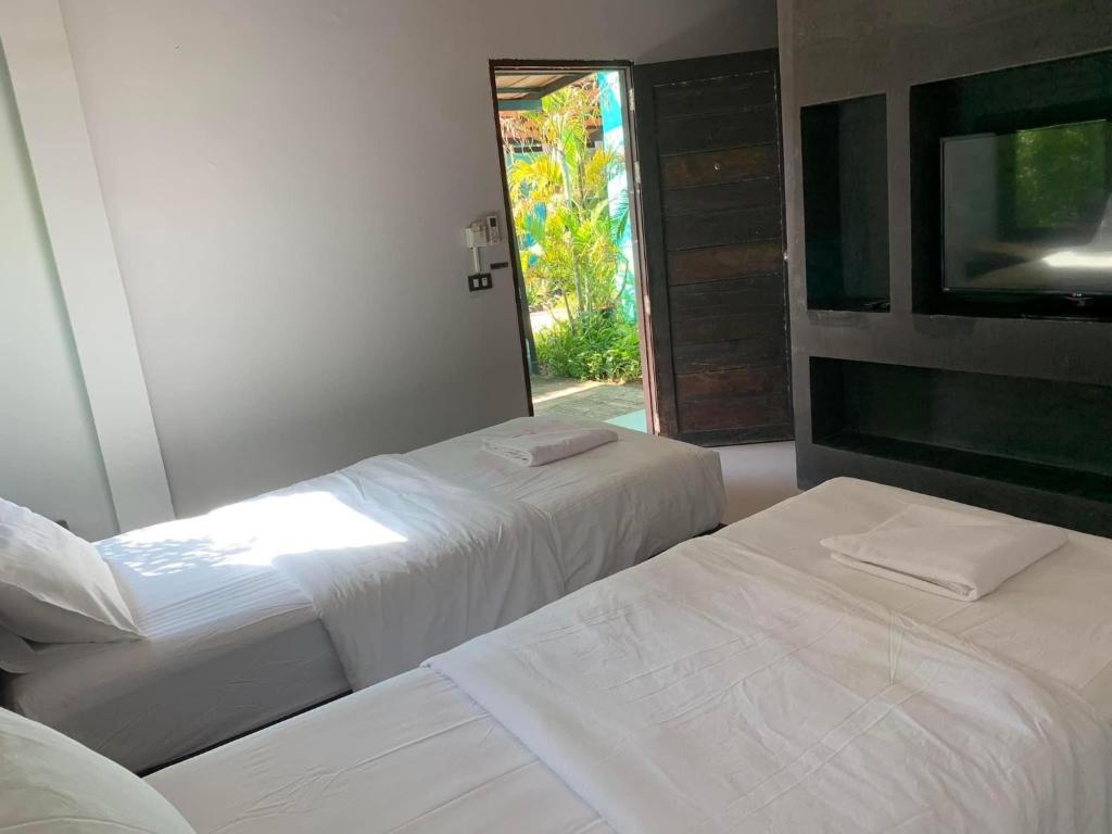 Postel nebo postele na pokoji v ubytování ยูสีเกด รีสอร์ท