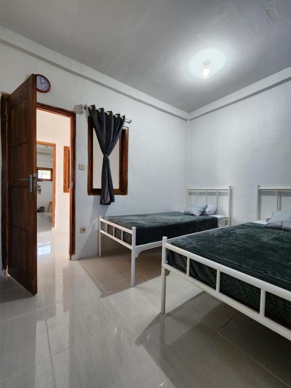 Postel nebo postele na pokoji v ubytování D'Flora Homestay