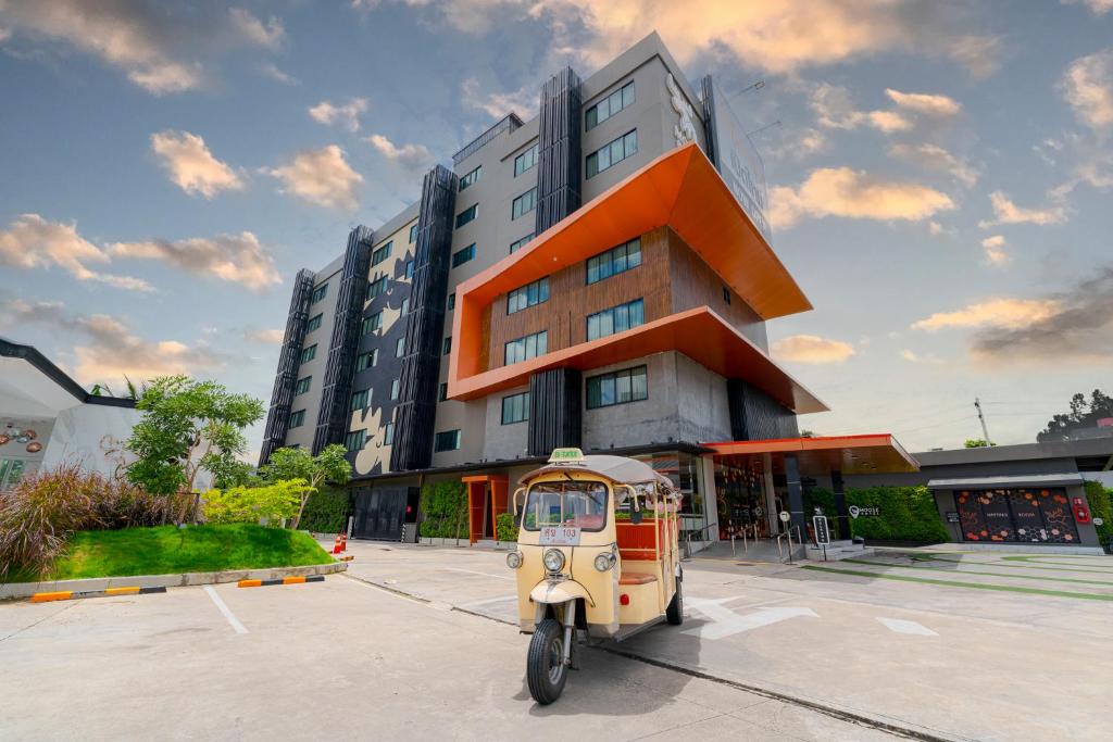 a small vehicle parked in front of a building at Moose Hotel Chiangmai in Chiang Mai