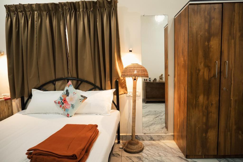 Postel nebo postele na pokoji v ubytování Nirvana Homestays