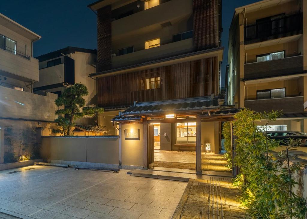 京都的住宿－RESI STAY Jisco Hotel Kyoto Goshonishi，夜晚在建筑物前的庭院