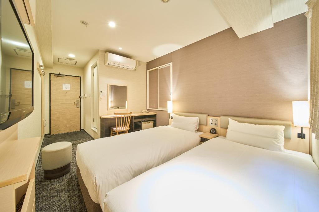 Postel nebo postele na pokoji v ubytování Via inn Kyoto Shijomuromachi