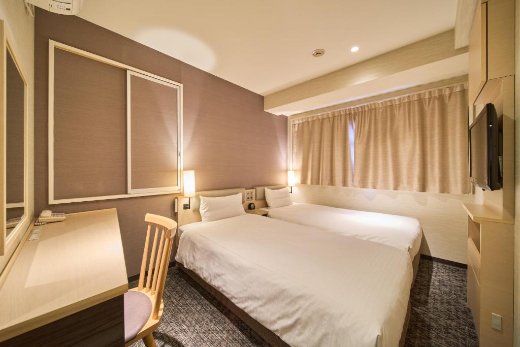 Postel nebo postele na pokoji v ubytování Via inn Kyoto Shijomuromachi