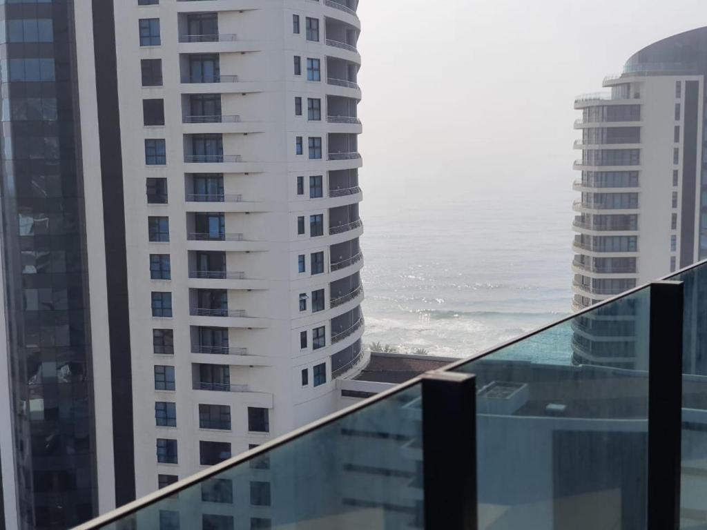 a view of the ocean from the balcony of a building at Oceans Lux 1 Bedroom - Seaview in Durban