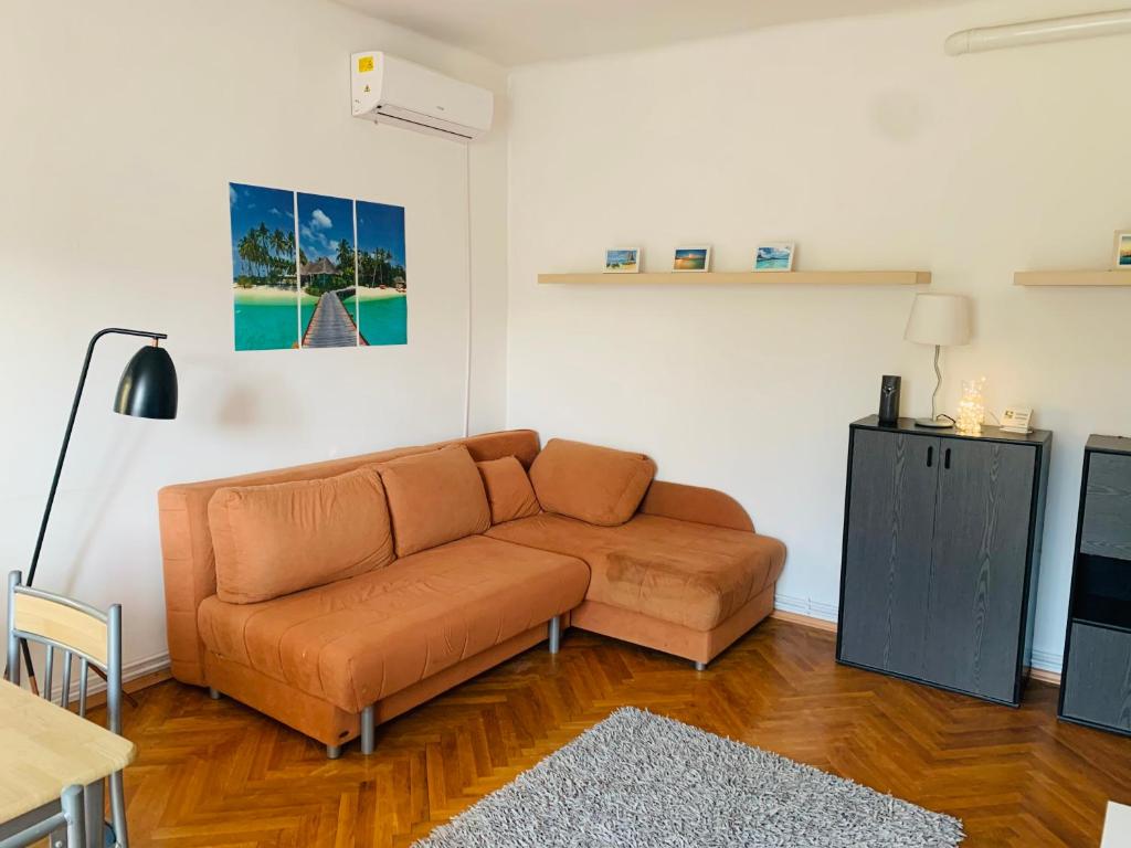 a living room with a couch and a table at Peaceful Haven in Budapest