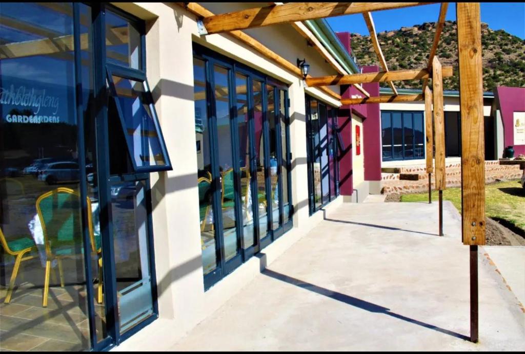 a store front with glass windows and awning at Matholeng Gardens Guesthouse in Foso