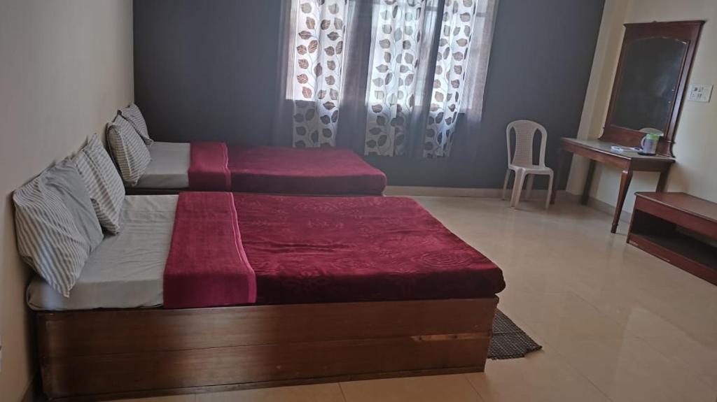Postel nebo postele na pokoji v ubytování MYSORE MAHALAKSHMI ROOMS