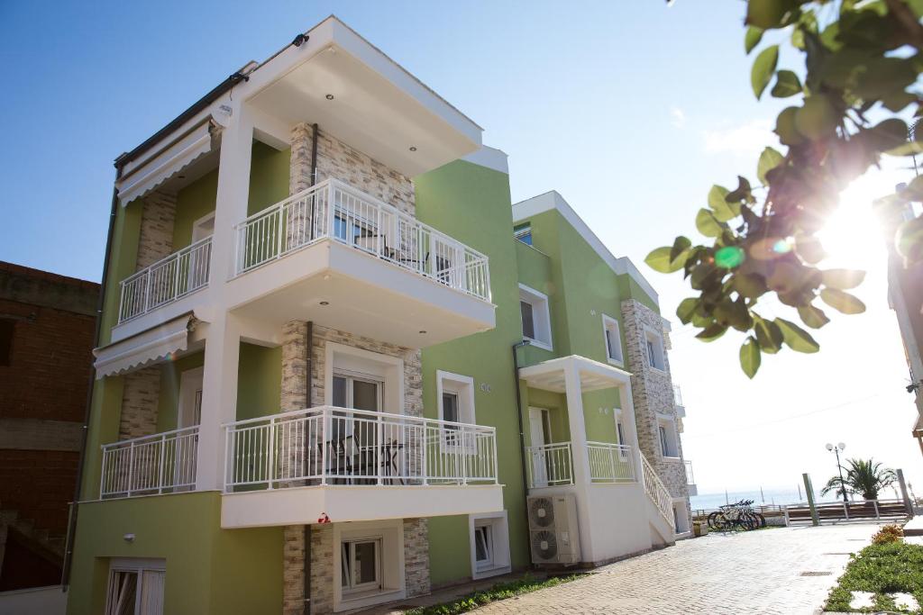 a green building with white balconies on it at Eco Green Living in Toroni