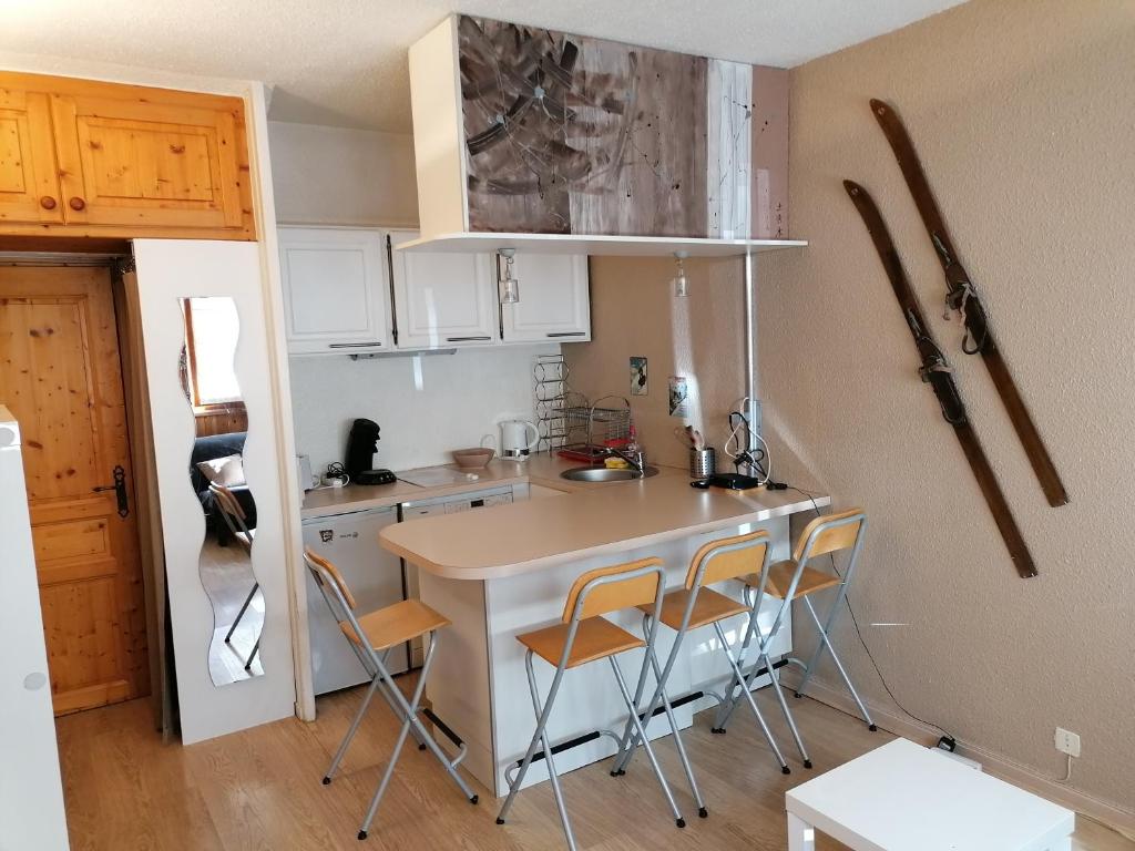 a small kitchen with a table and chairs at Steph et Caro Studio Les Cassettes in Valloire