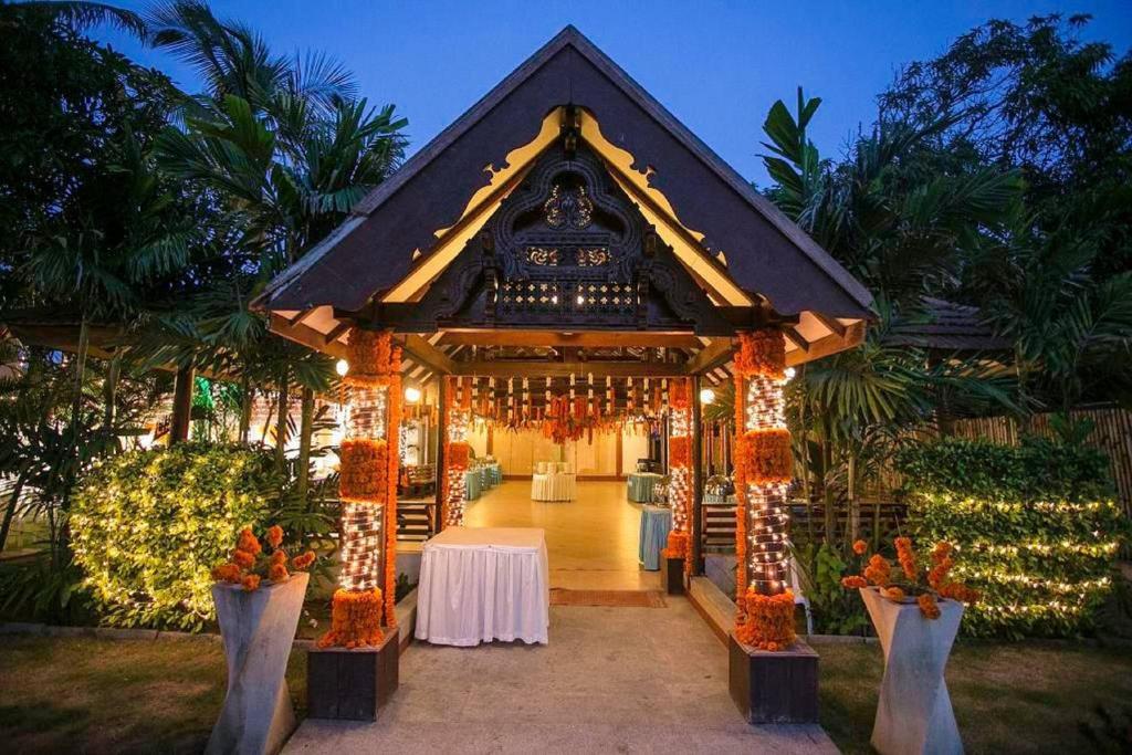 a gazebo with a table and lights at Green Meadows Resort in Chennai
