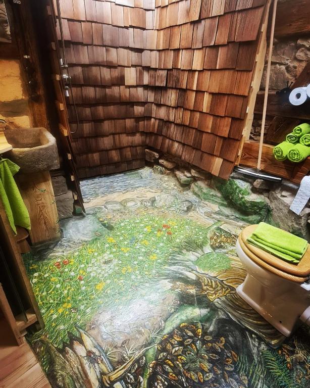 a bathroom with a mosaic floor with a toilet on it at Wohnen im Denkmal. Erholung pur. in Sulz am Neckar