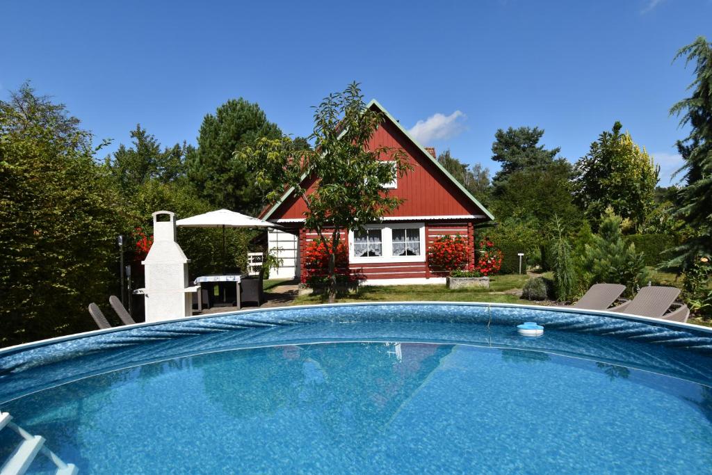 a house with a swimming pool in front of a house at Chalupa Alexandra in Kacanovy