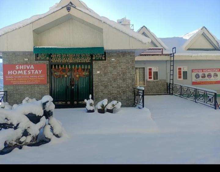 a building with snow on the ground in front of it at Shiva Homestay in Kīar
