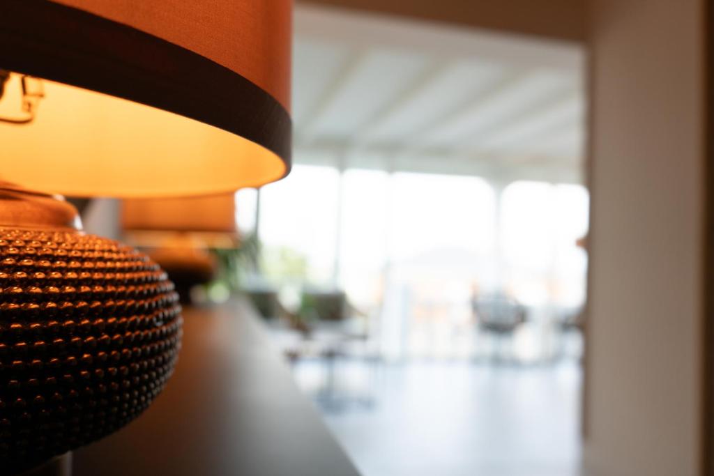 a close up of a lamp in a living room at Hotel Don Diego in Suances