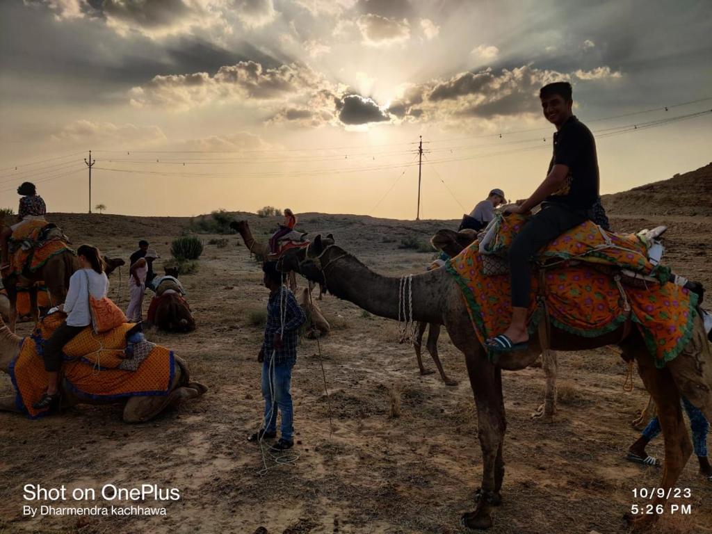 a man sitting on a camel in the desert at The Elite Castle in Jaisalmer