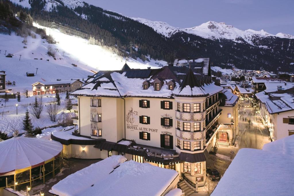 un grande edificio con la neve sopra di esso di Hotel Alte Post a Sankt Anton am Arlberg