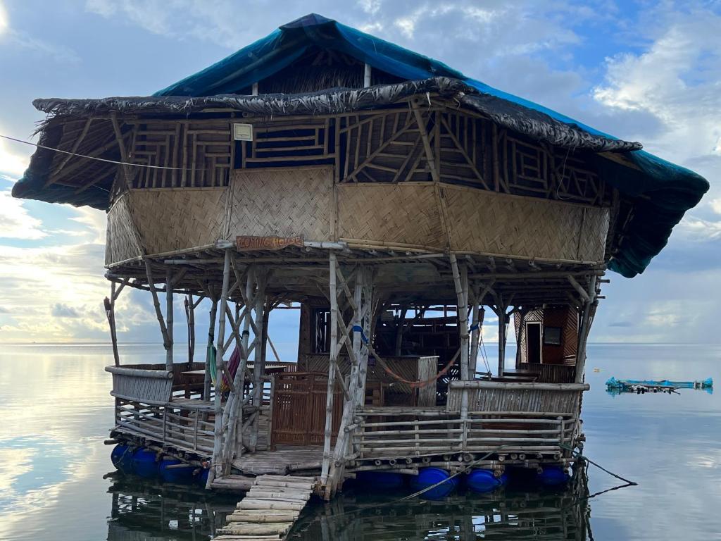 a house on the water in the water at Bamboo Nest Beachfront in Puerto Princesa City