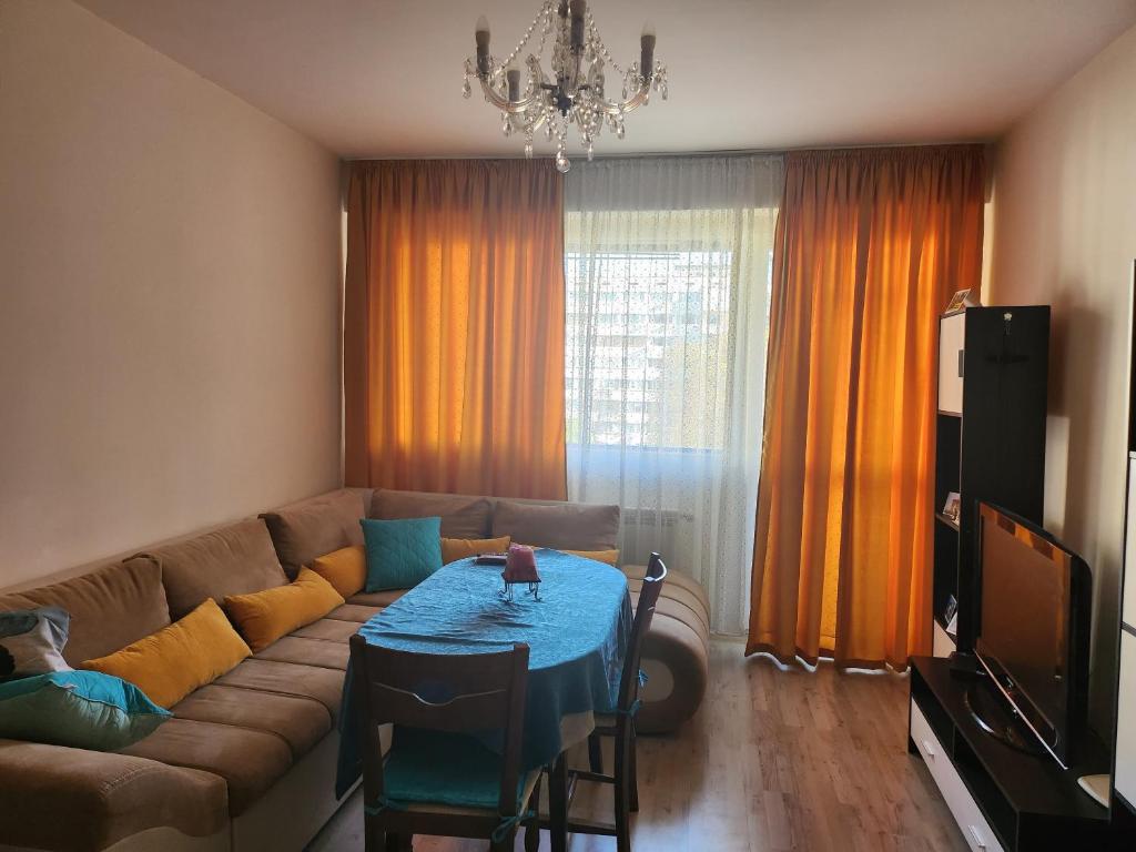 a living room with a couch and a table at Best apartment- airport in Sofia