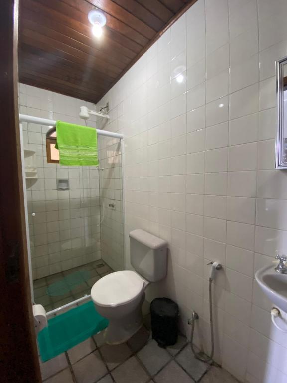 a bathroom with a toilet and a shower and a sink at Recanto do Abraao Ilha Grande in Angra dos Reis