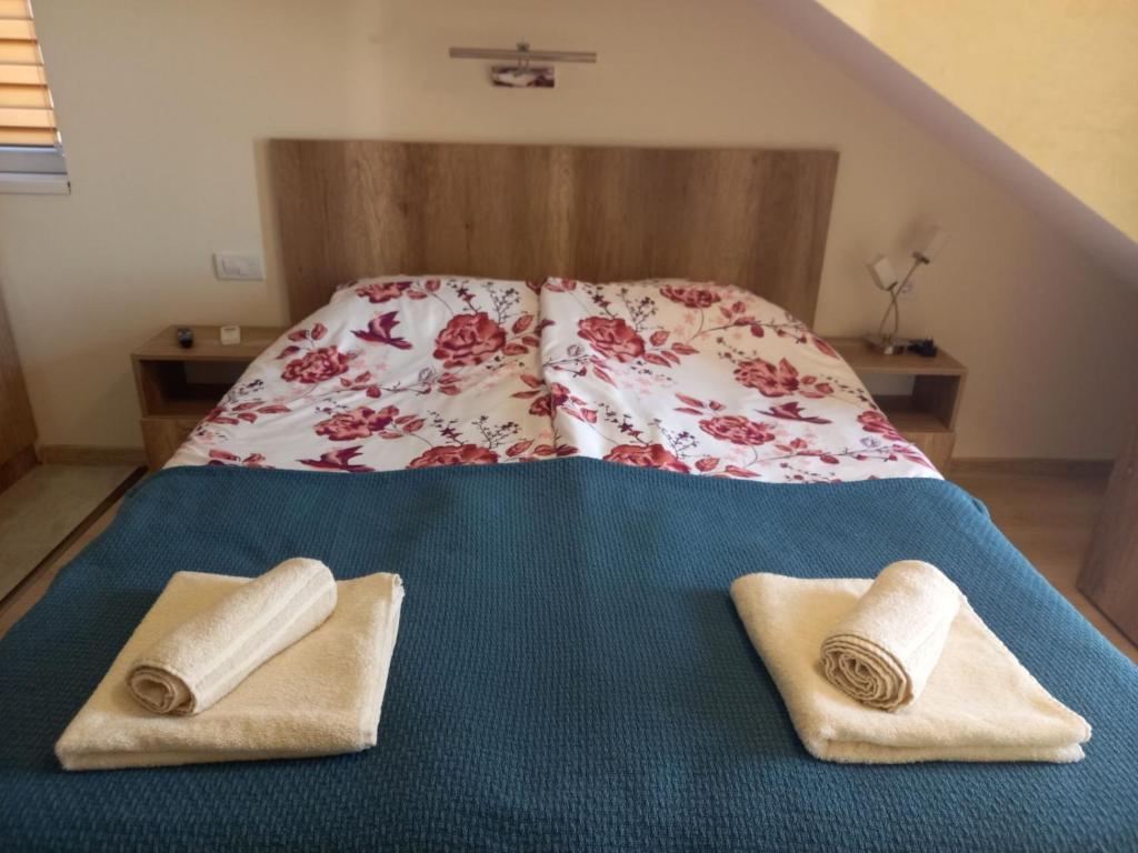 a bed with two towels on top of it at Apartman LANA 2023 in Arandjelovac