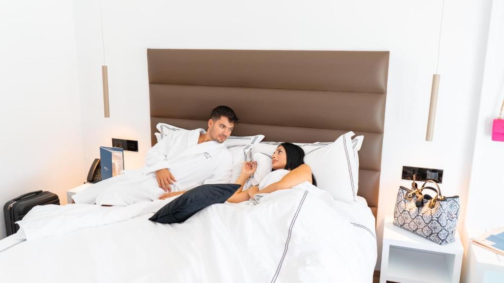 A bed or beds in a room at POPULA - The Lifestyle Hotel