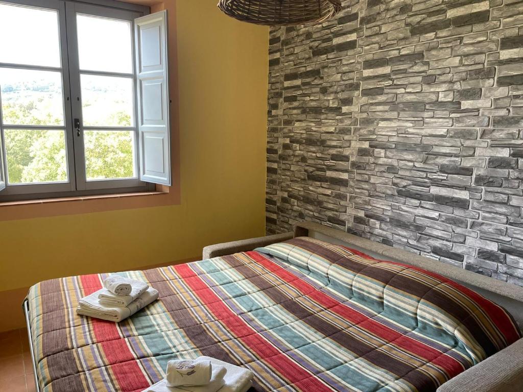 Łóżko lub łóżka w pokoju w obiekcie Agriturismo In Campagna