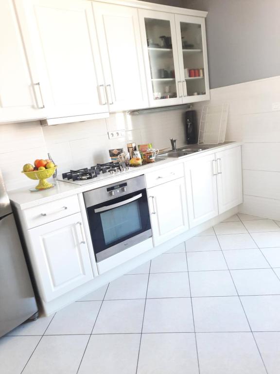 a white kitchen with white cabinets and a sink at ZEN in Marseille