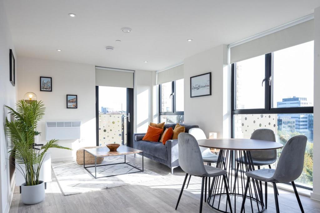 a living room with a couch and a table and chairs at GuestReady - A modern getaway in Vauxhall in Liverpool