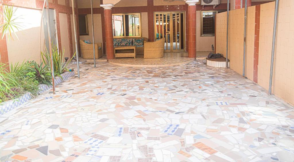 a lobby with a floor covered in mosaic tiles at Magnifique Maison de ville Bord de mer Cotonou Fidrjossè in Cotonou