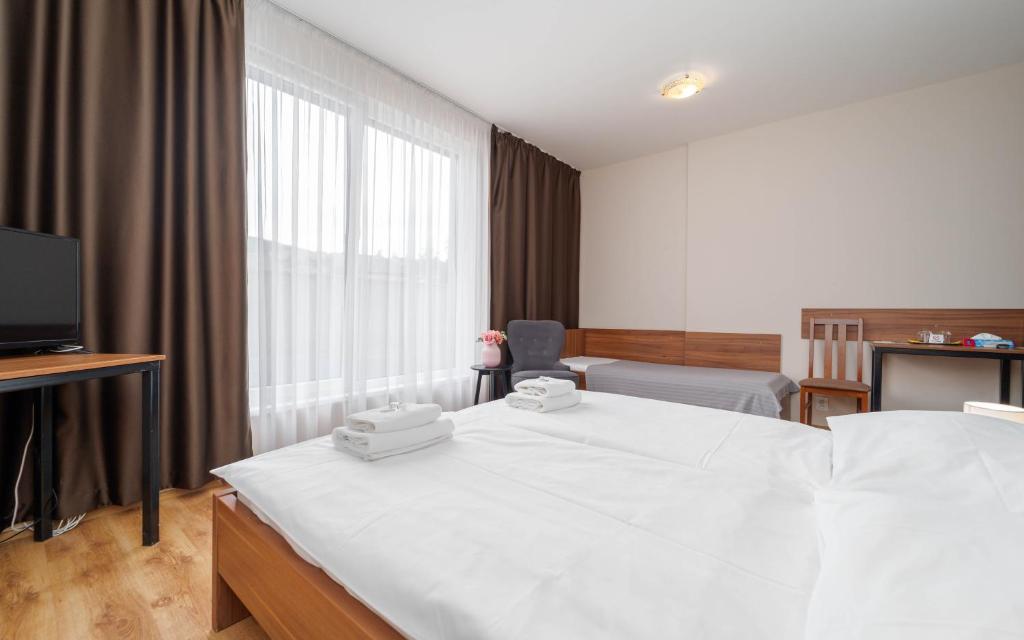 Postel nebo postele na pokoji v ubytování Hotel Aréna