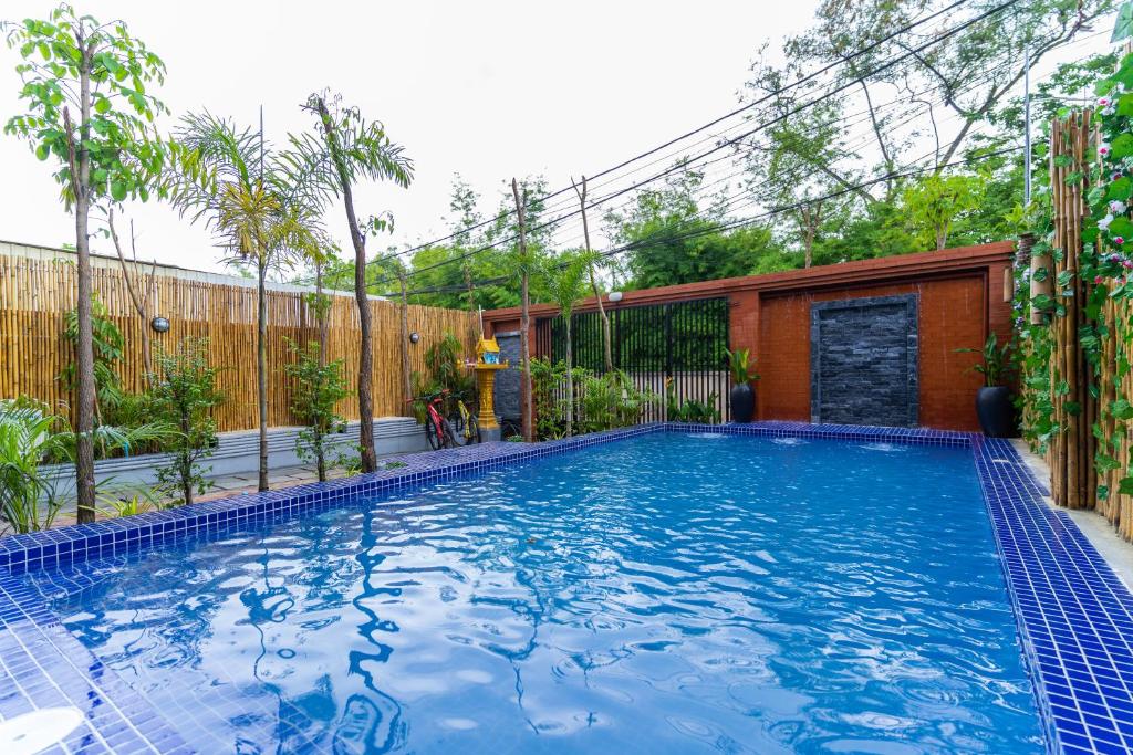 a swimming pool in the backyard of a house at Angkor Rithy Residences in Phumi Ta Phul