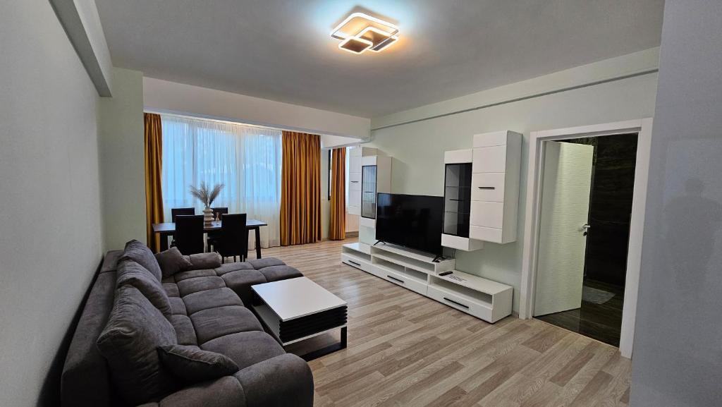 a living room with a couch and a flat screen tv at Nordic Residence 23 in Suceava