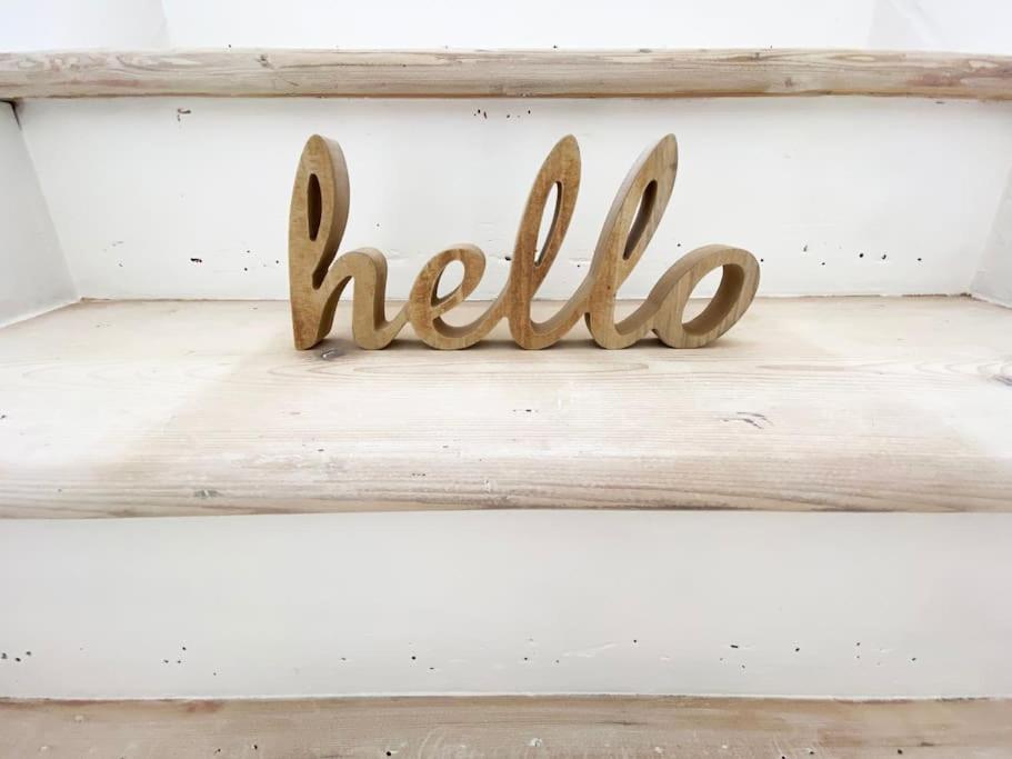a wooden sign that says hello on a shelf at Apartment One at The Courtyard, Number 11 in Crewe