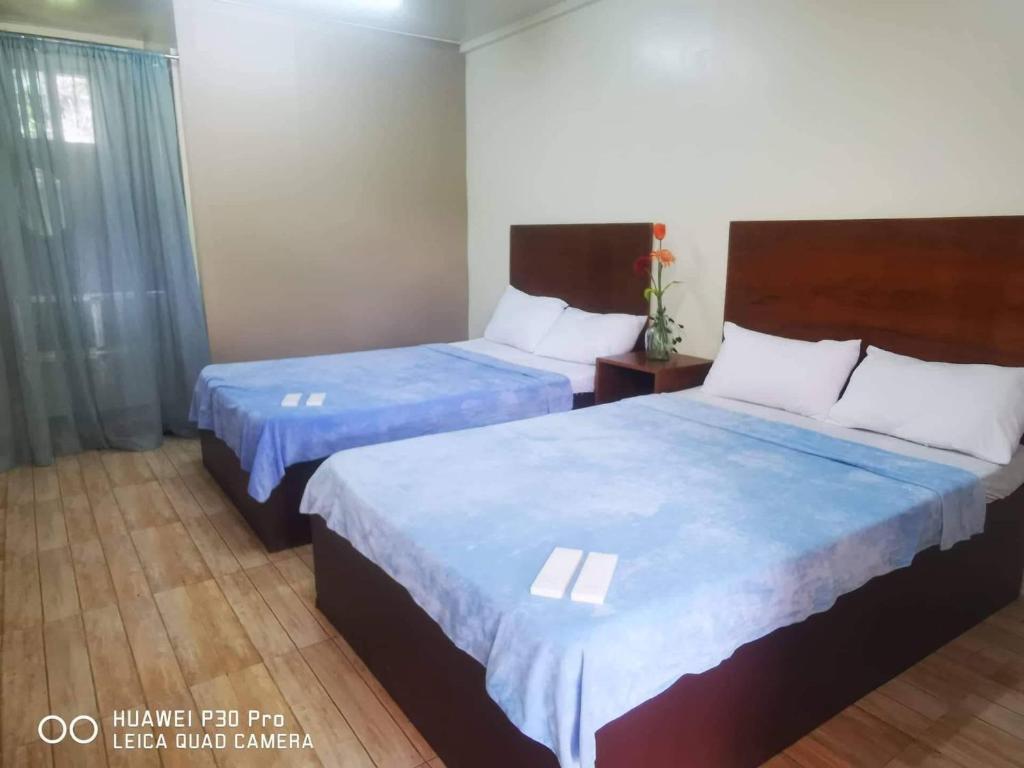 Postel nebo postele na pokoji v ubytování CASA LA EL BAGUIO