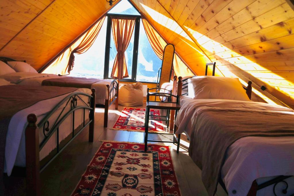 a room with four beds in a tent at Cottage Mtachy in Stepantsminda