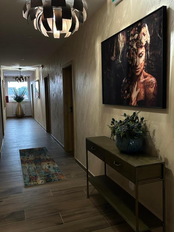 a hallway with a painting of a woman on the wall at Villa Potôň 2023 in Horná Potôň